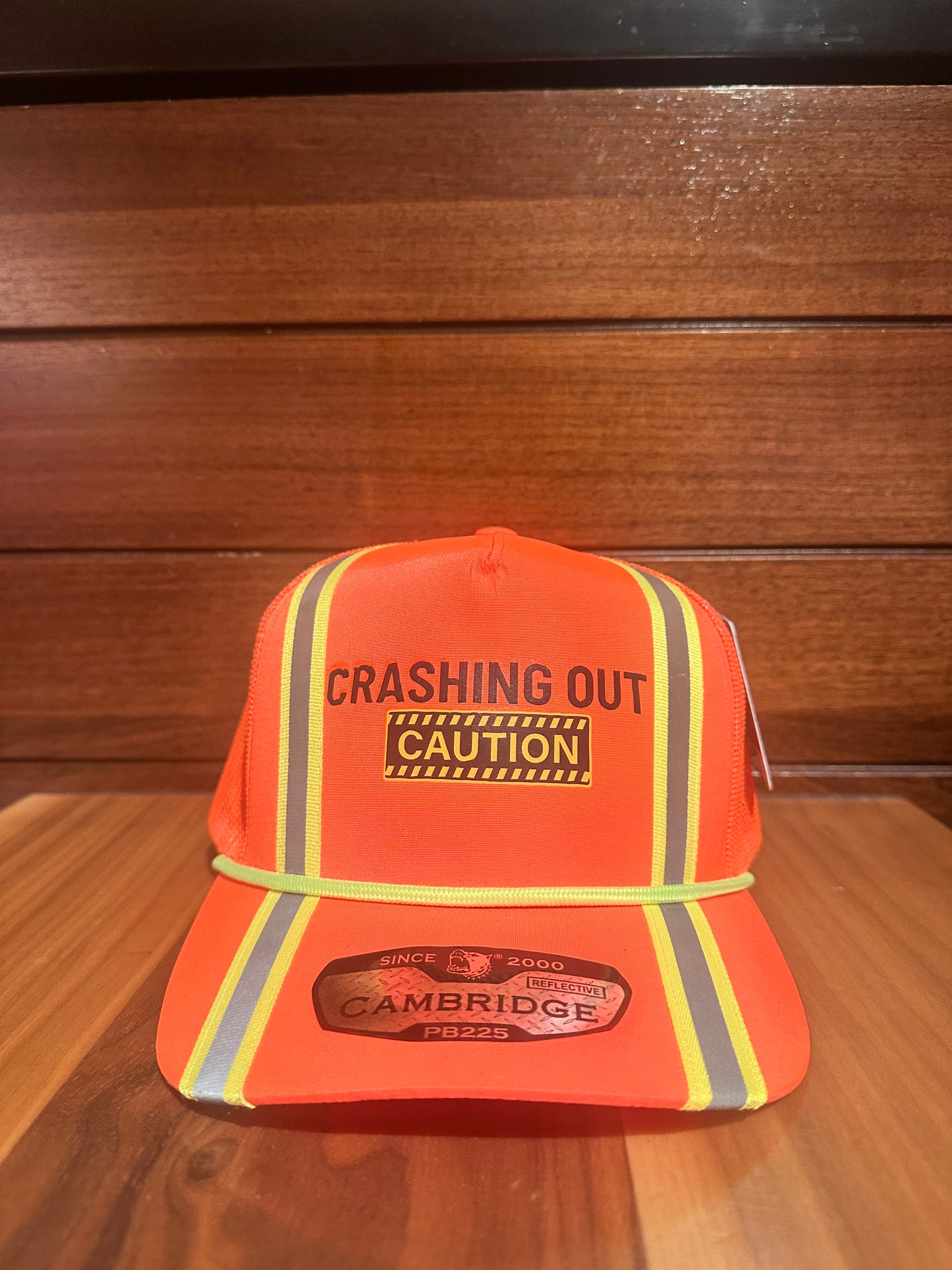 Crashing Out Orange Trucker Hat with yellow and silver stripes